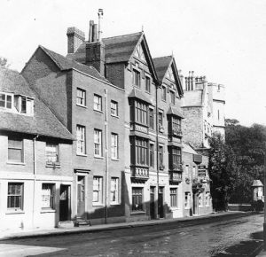 Black and white photograph from 1903 showing the end of Park Street, featuring the Two Brewers Public House, first mentioned in 1792 licensing documents. Adjacent is a distinctive double-gabled Victorian building designed by Irish architect Patrick Byrne in 1886, later demolished around 1909. The image shows the streetscape with period architecture and a few pedestrians.