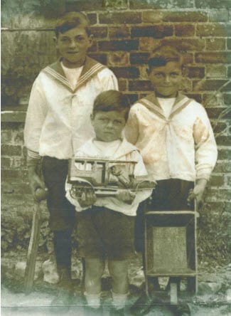 Walter, with cricket bat and ball; Frederick and John Charles, with a wheelbarrow.