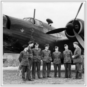 Seven Royal Air Force airmen in uniform stand together on an airfield in front of a World War II bomber aircraft.